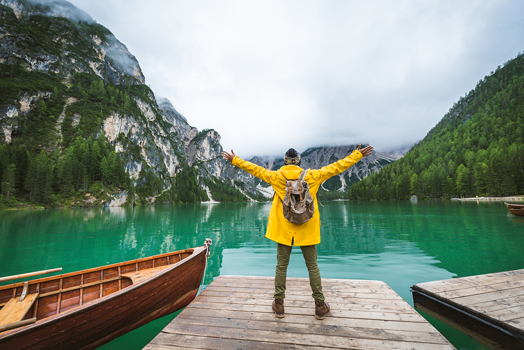 man enjoying the view of a lake