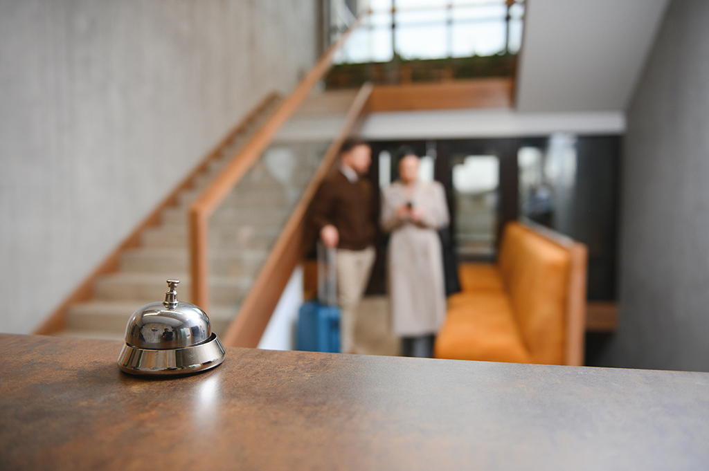 Reception bell with customers in the background